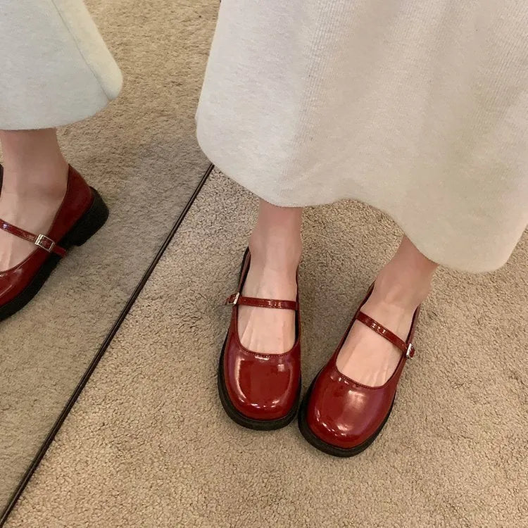 Women's flat-heeled leather shoes with round toe in red, black, and grey colour options showing vintage French styling