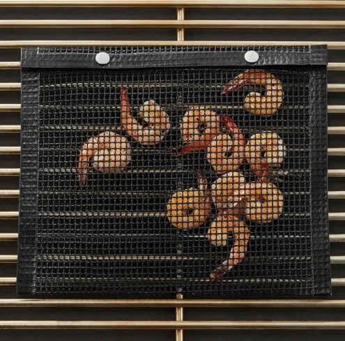 Reusable non-stick BBQ grill mesh bag on a grill with food, heat-resistant and food-safe