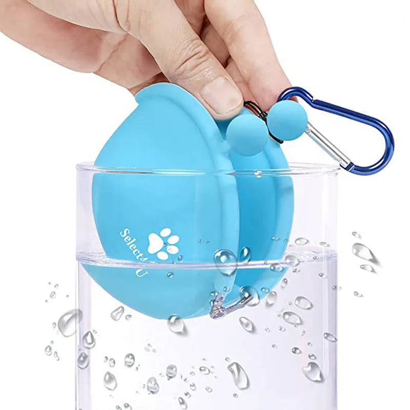 Yellow silicone dog treat pouch with hook and loop strap, shown on a waistband.