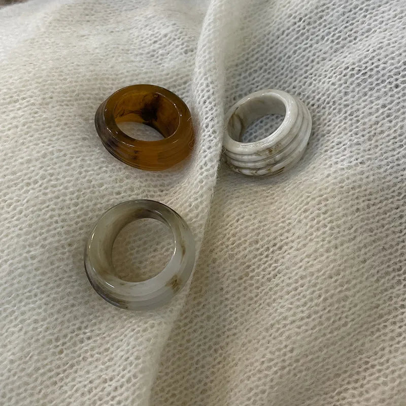 Chinese style irregular geometric resin wide ring in neutral colours on display
