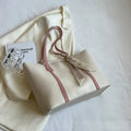 Canvas bucket tote bag with crossbody strap showing sandwich pocket organisation and soft construction