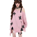 Women's off-the-shoulder loose fit sweater with ripped detailing and tassel trim in black, on model
