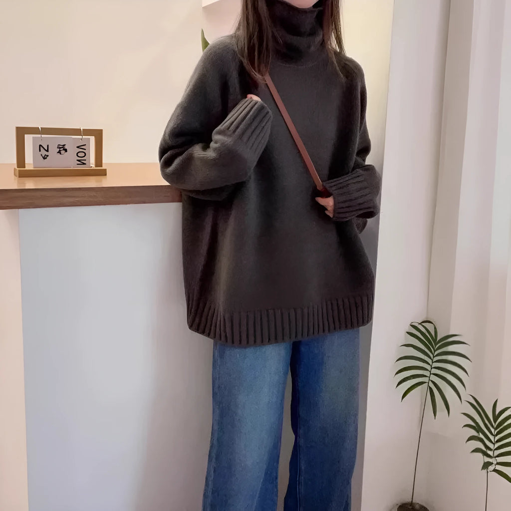 Women's loose grey turtleneck sweater with a thick, textured curling pile collar