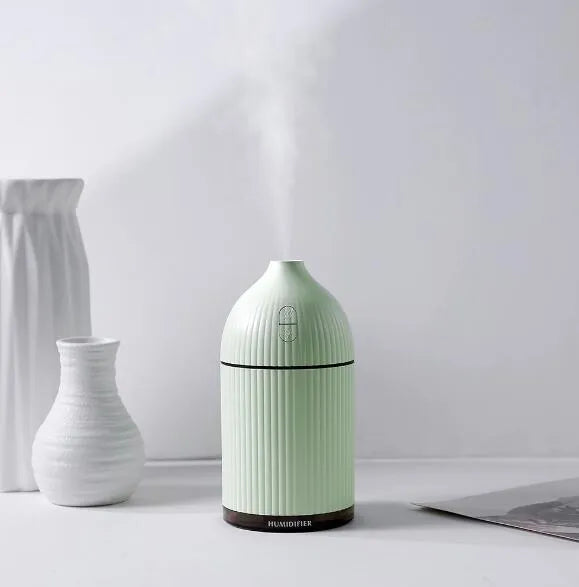White USB aromatherapy diffuser humidifier with 300ml capacity and LED light on wooden table