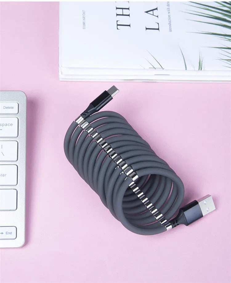 White magnetic nano data line with aluminium alloy joints and multiple connector heads on a desk