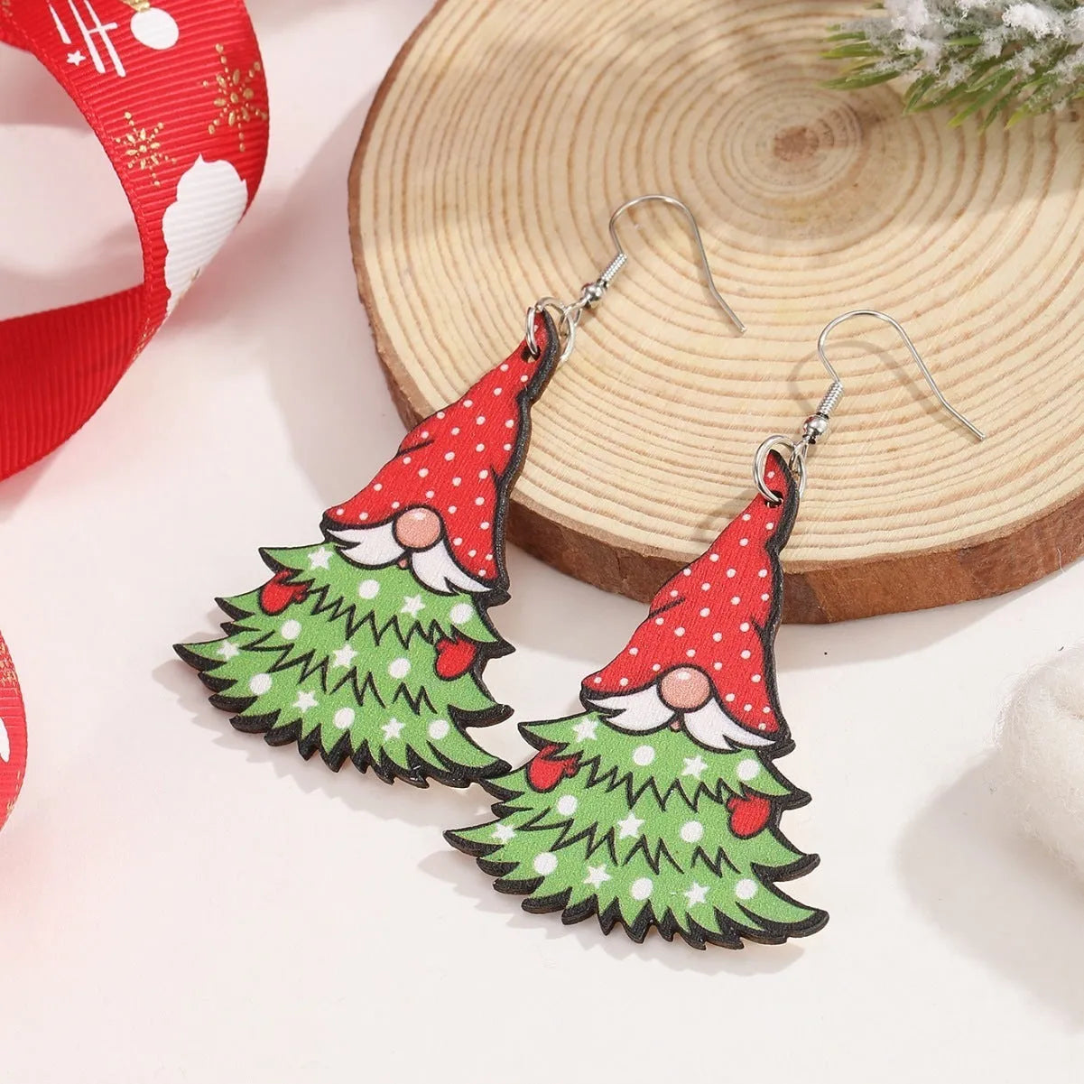 Wooden Christmas earrings with geometric tree and snowman designs featuring Santa Claus elements