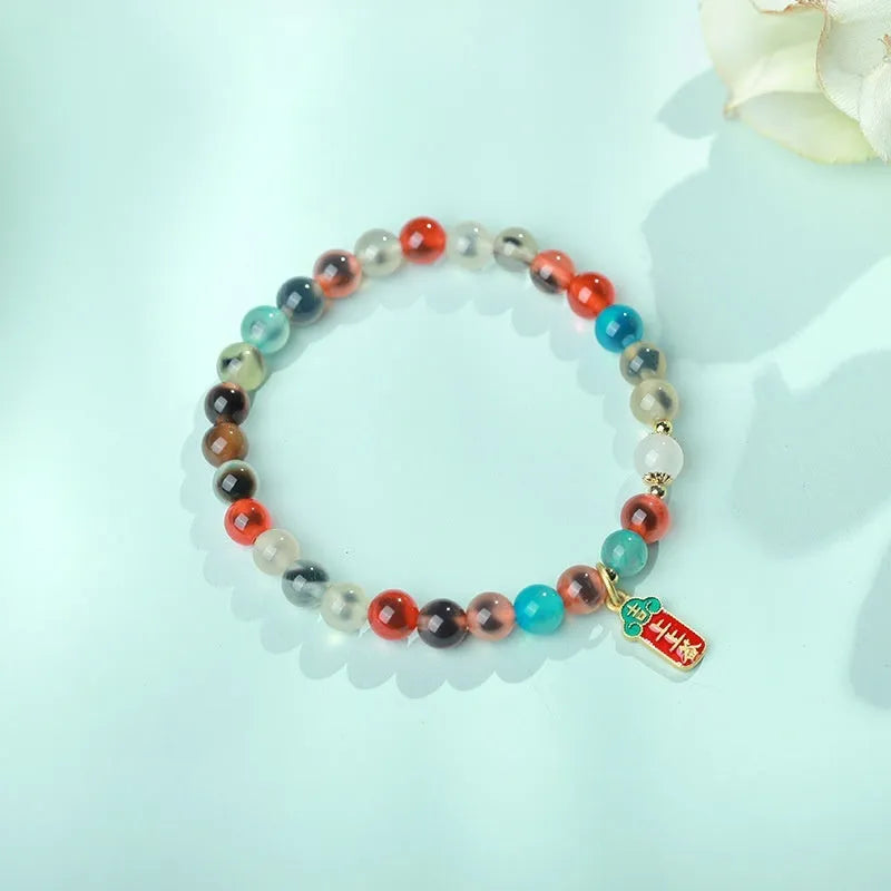 Women's agate bracelet with copper coin snake chain and coloured glaze detailing in geometric bead design