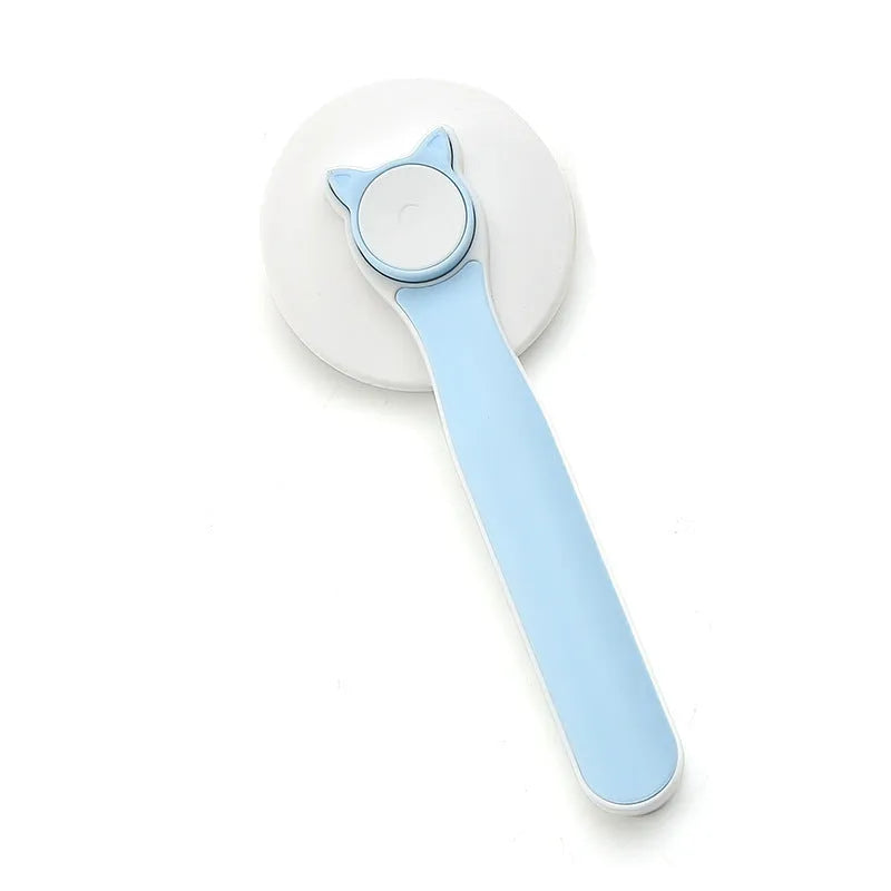 Blue self-cleaning slicker brush for dogs and cats on a table, showing ergonomic rubber handle and stainless steel pins.