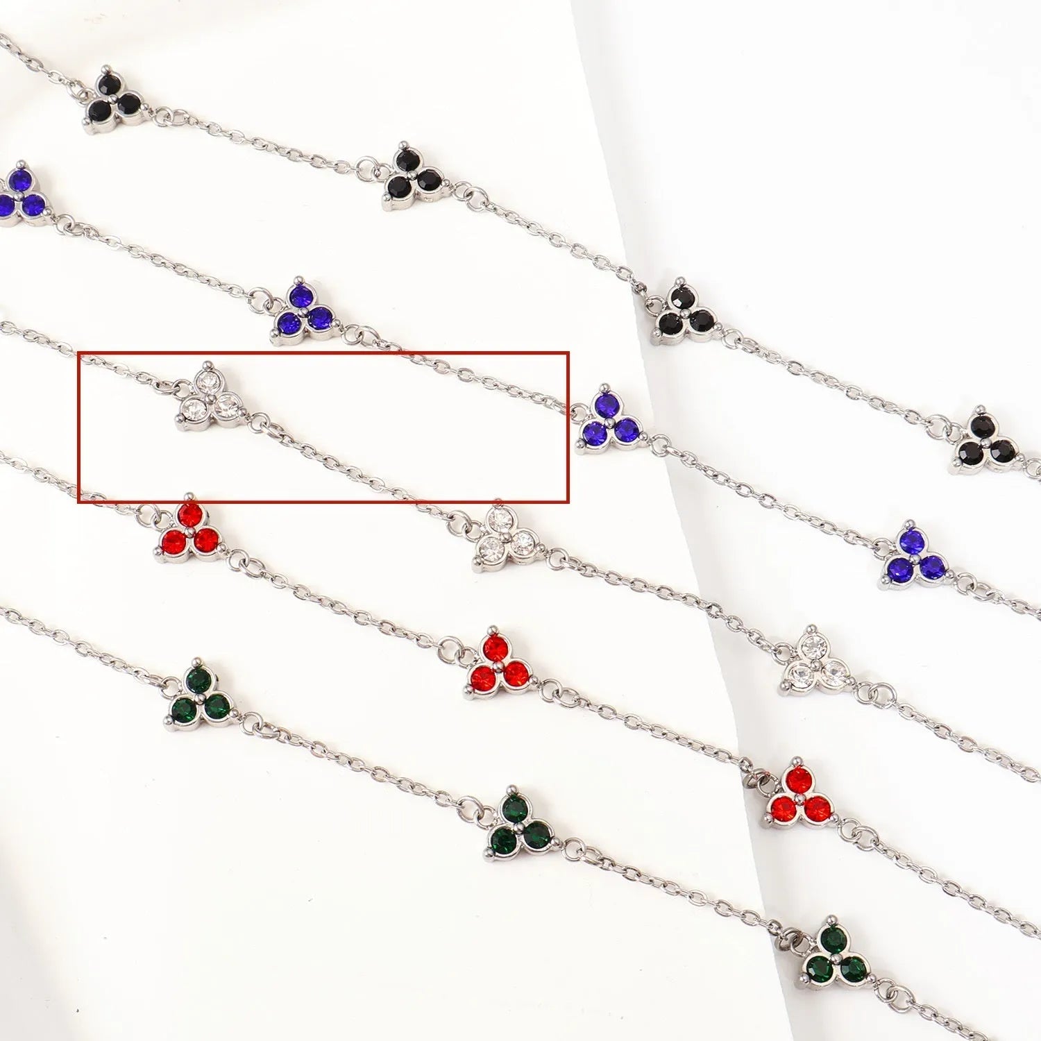Women's stainless steel geometric bracelet with triangle design and three-diamond centrepiece in gold or steel finish.
