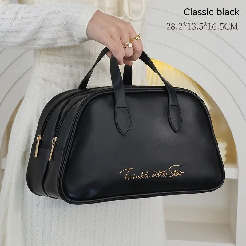 Large leather travel toiletry bag open to show dry and wet separation compartments.