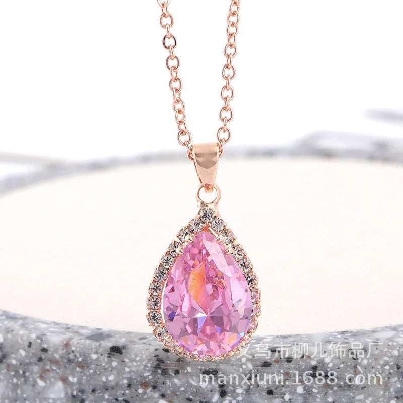 Rose gold geometric drop necklace with rhinestone details in pink colour option