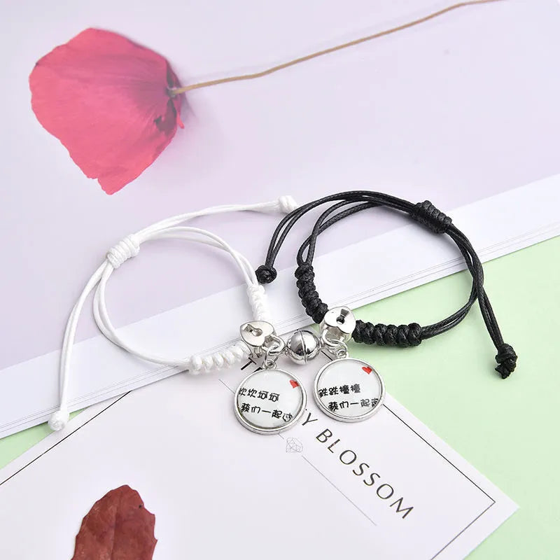 Magnetic clasp couple bracelets with alloy construction and symbolic designs including crown and love lock motifs.