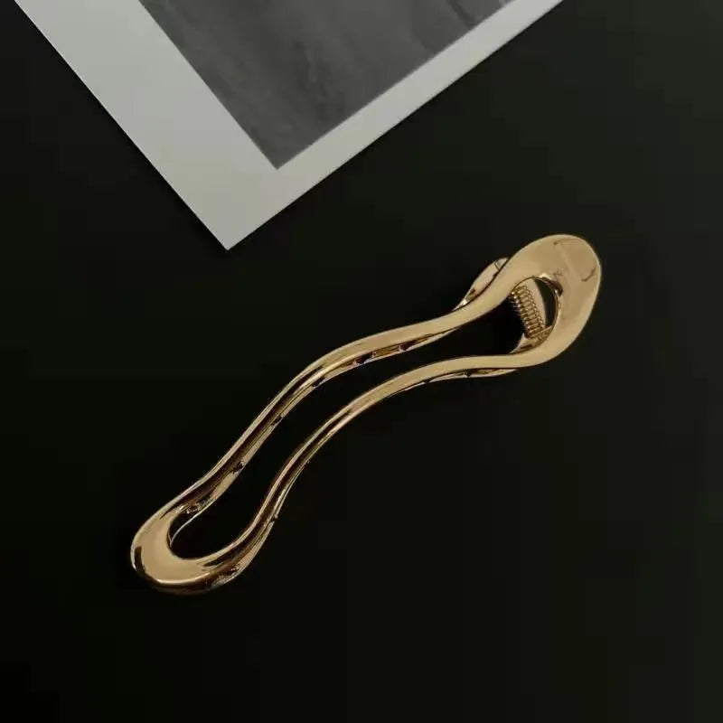 Gold and silver zinc alloy hair clip barrettes in arc, square, and triangle shapes.