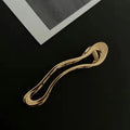 Gold and silver zinc alloy hair clip barrettes in arc, square, and triangle shapes.