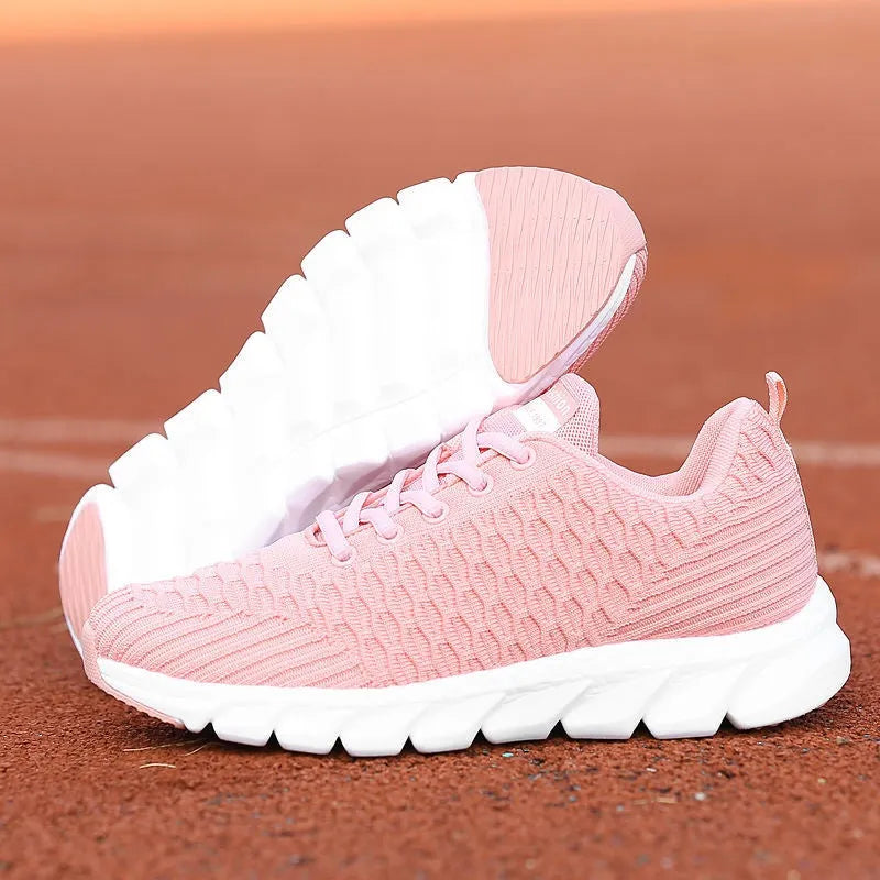 Women's black running shoe with fly weave upper and textured wear-resistant outsole.
