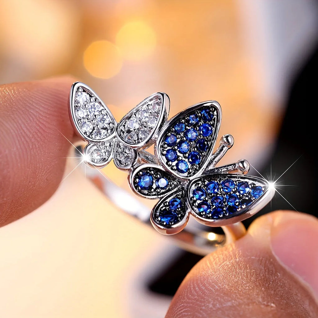 Blue and white copper butterfly ring for women TJZ40135 on plain background