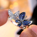 Blue and white copper butterfly ring for women TJZ40135 on plain background