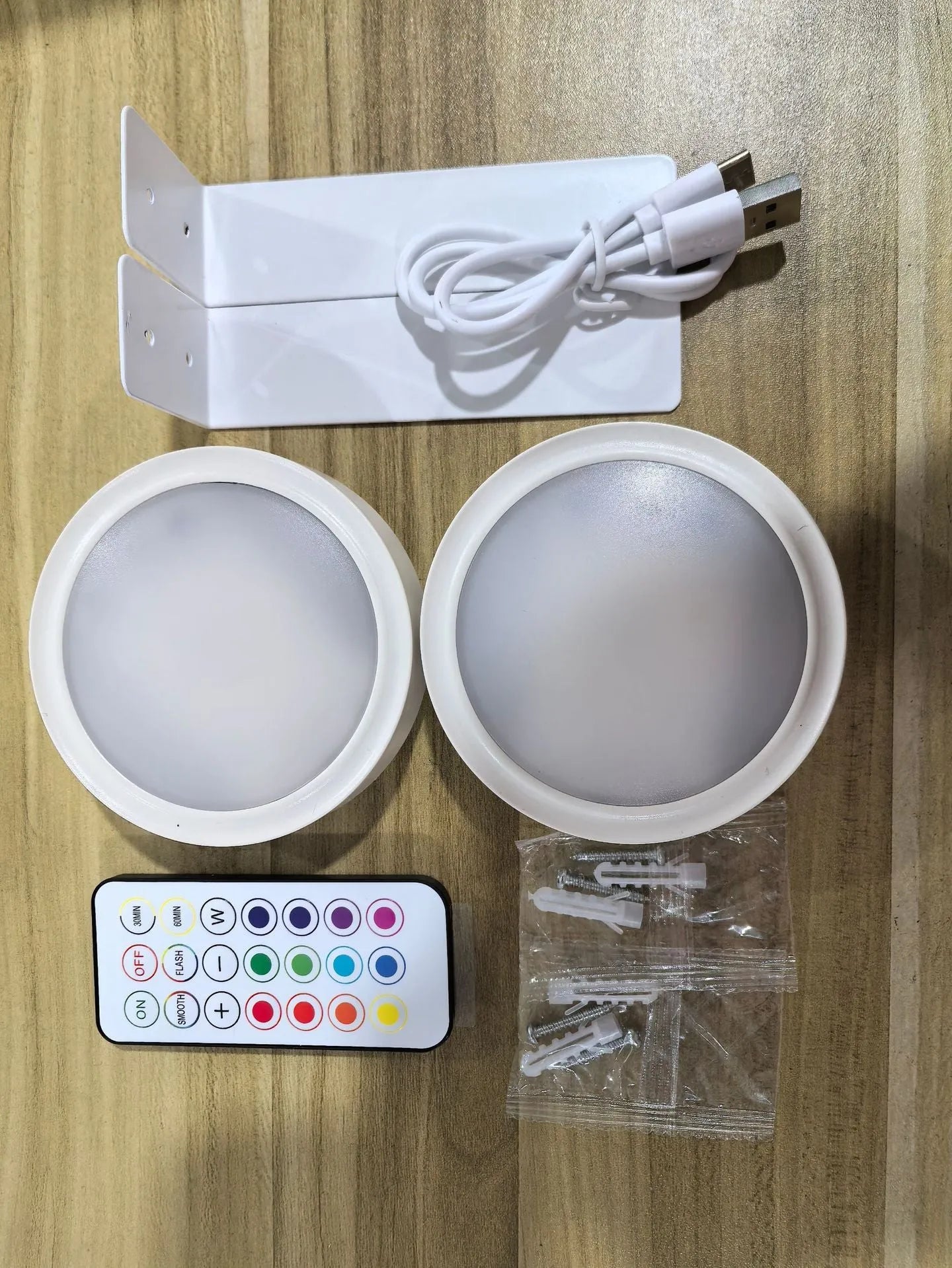 Wireless LED painting lamp with a magnetic mounting belt and remote control in black finish.