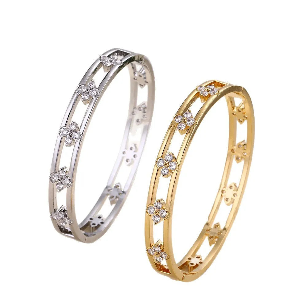 Women's hollow bracelet with zircon stones and four-leaf clover charm in gold and silver options