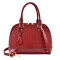 Shiny black PU crossbody bag showing structured shell shape and dimensions