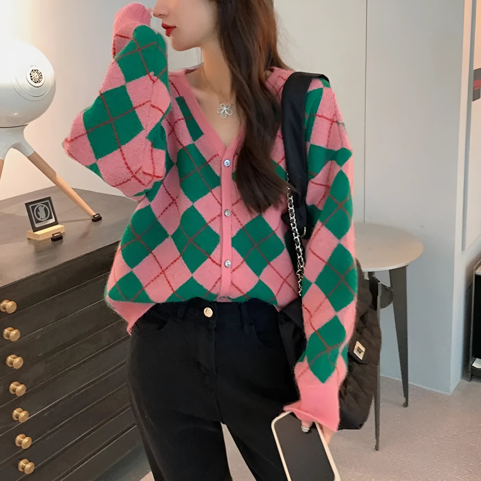 Casual knitted cardigan in acrylic fabric shown in a macaron colour palette on a hanger.