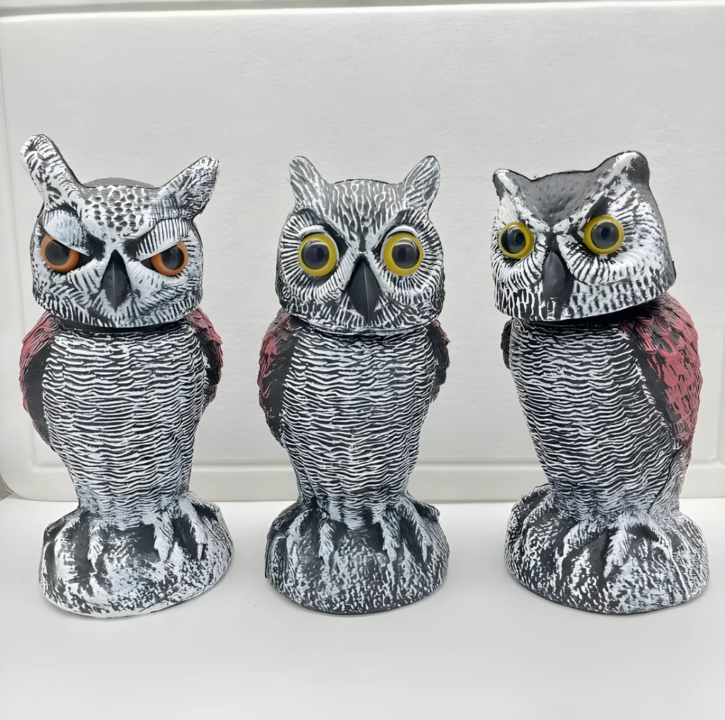 Artificial owl bird scarer decoy with shaking head motion in outdoor setting