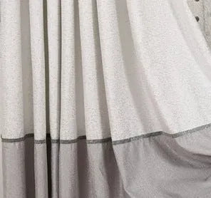 A single blackout curtain panel hung on a track, demonstrating its light-blocking fabric and hook-style header.