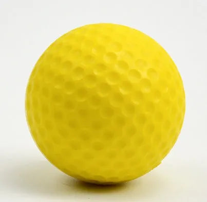 10 yellow PU foam indoor practice golf balls with 41mm diameter on a green surface