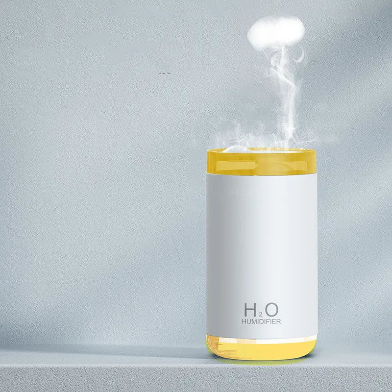 Jellyfish-shaped humidifier emitting smoke ring mist patterns with warm night light glow
