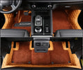 Custom black PU floor mats installed in a Mitsubishi Outlander footwell.