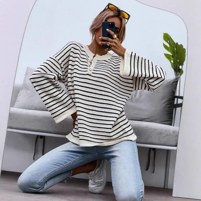 Black and white striped women's loose-fit long sleeve top with drop shoulders and button front.