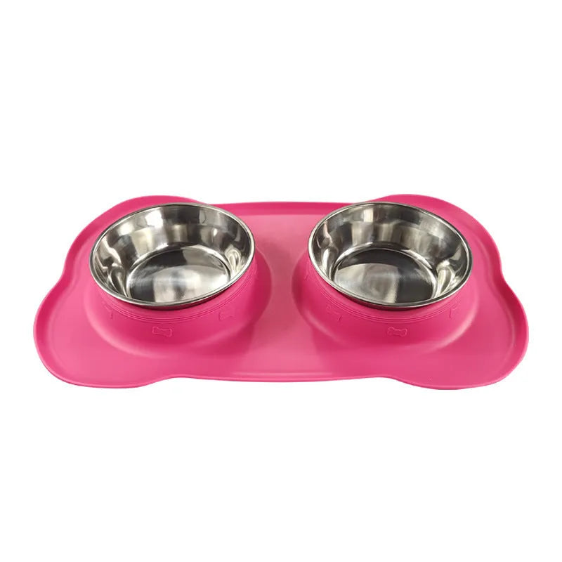 Large silicone double dog bowl in blue with two compartments for food and water on a kitchen floor.