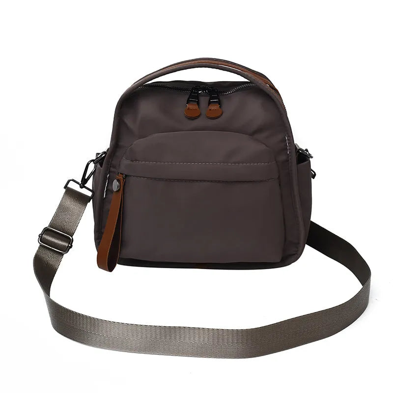Vegan leather crossbody bag in black with double-stitched contrast thread, YKK zippers, and reinforced base
