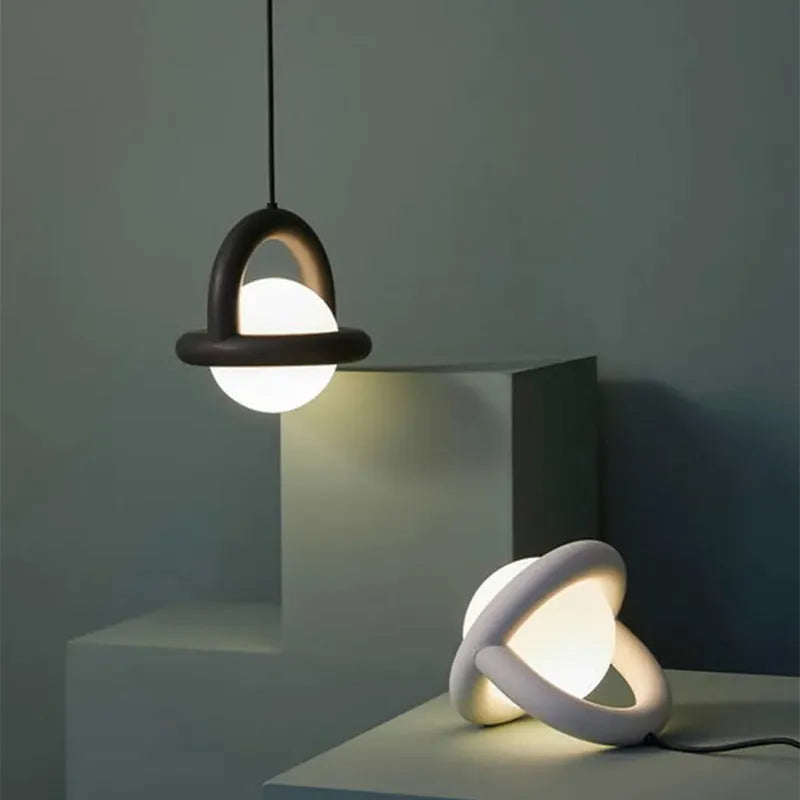 Modern Nordic-style pendant hanging lamp in a matte black finish with warm light.