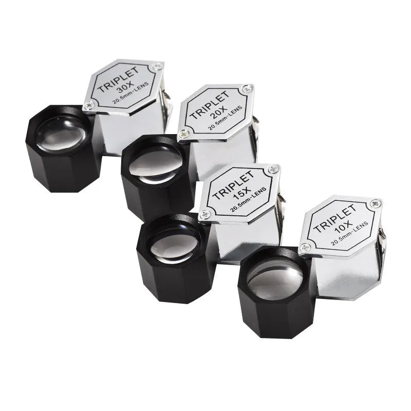 Handheld portable magnifying glass for jewellery and coin inspection with metal frame.