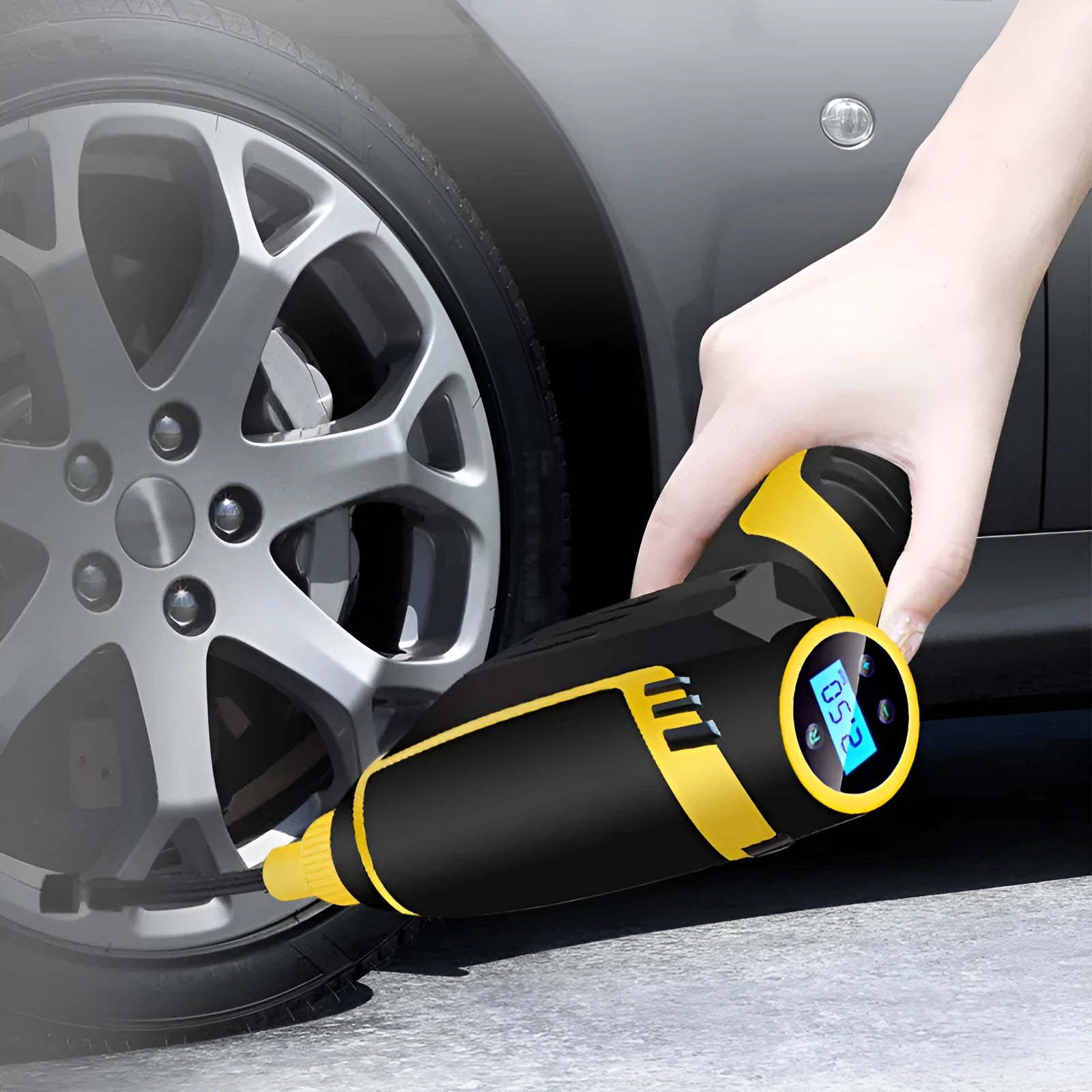 Black handheld digital LED car air compressor with 120W power and auto stop on a dark background