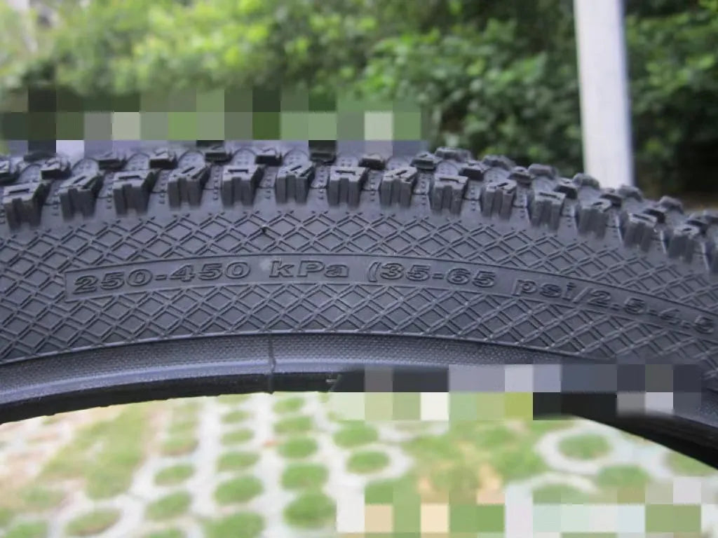 Ultralight puncture-proof mountain bike tyre shown in black with white label sidewall option.