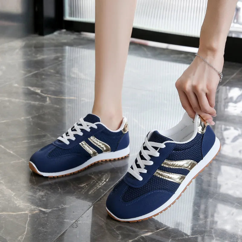 Blue women's sports shoes with cross shoulder straps, round toe, and flat rubber sole.