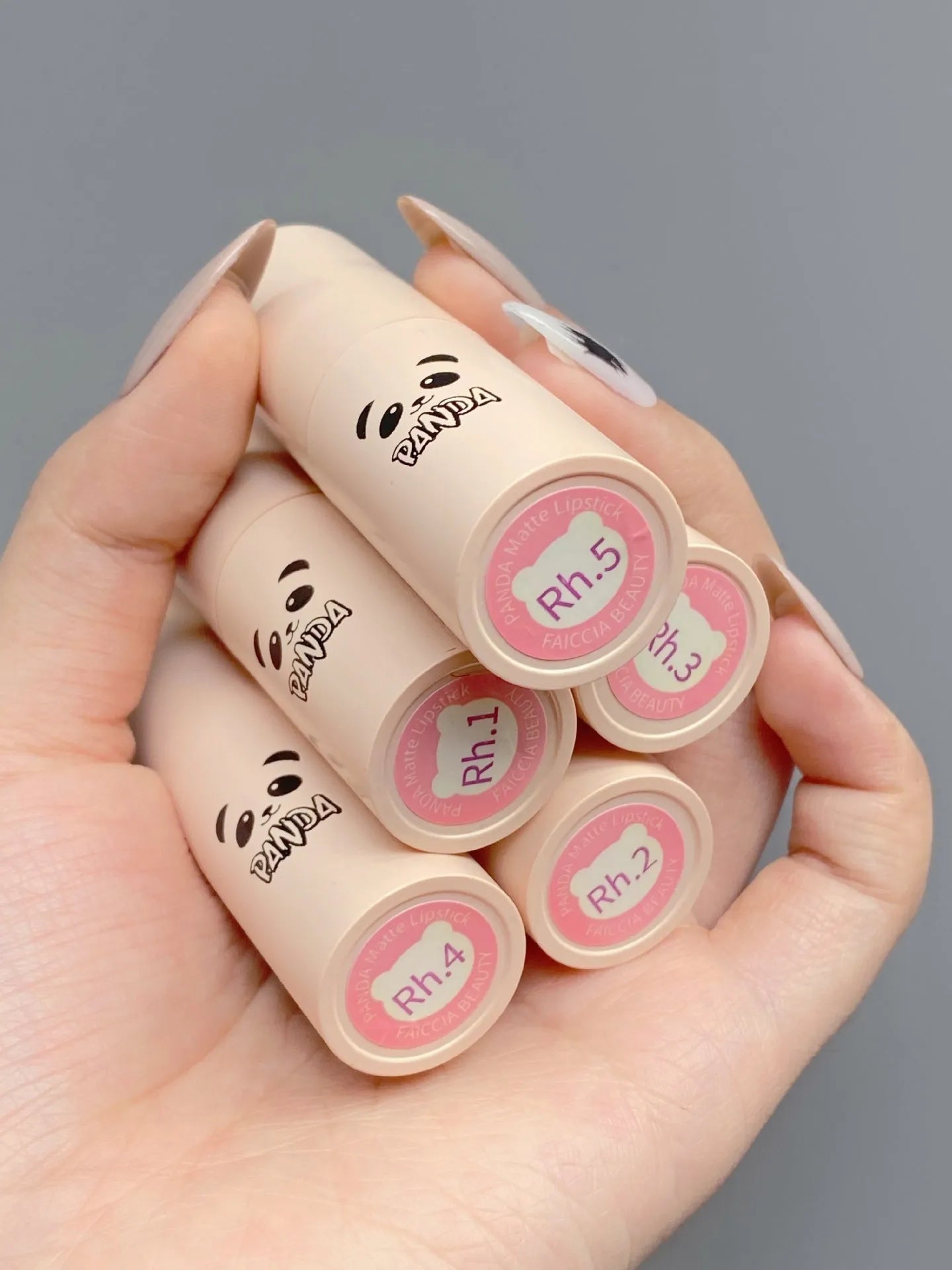 Little white tube matte velvet lipstick with five colour swatches Almond Cinnamon, Amber orange brown, Dirty Orange, Jujube Red Brown, White Peach Bean Paste