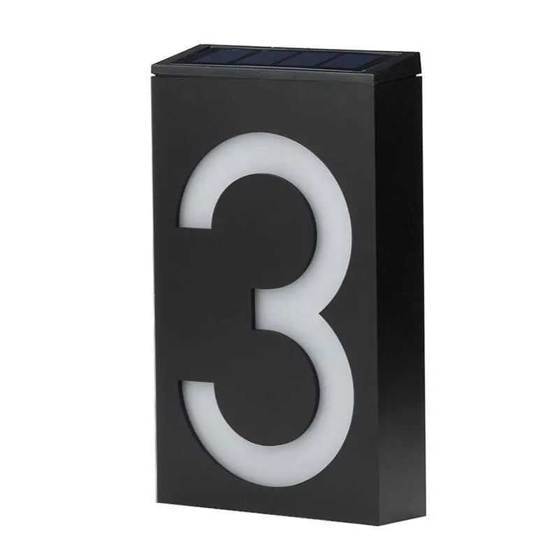 Solar powered outdoor house number light with white LEDs and wall mount.