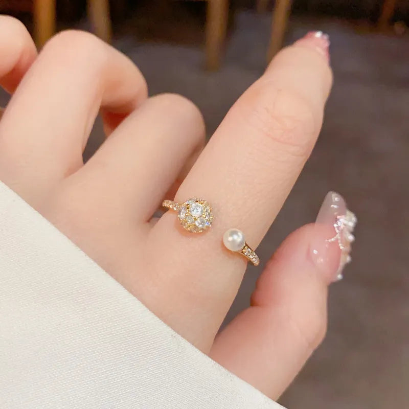 Open-end geometric pearl ring with round zircon accents in gold or silver finish