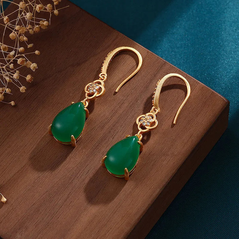 Gold-plated drop agate earrings on display showing alloy base and stone pendant