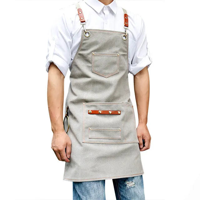 Canvas apron with cross-back straps in camel colour for cafe or baking work