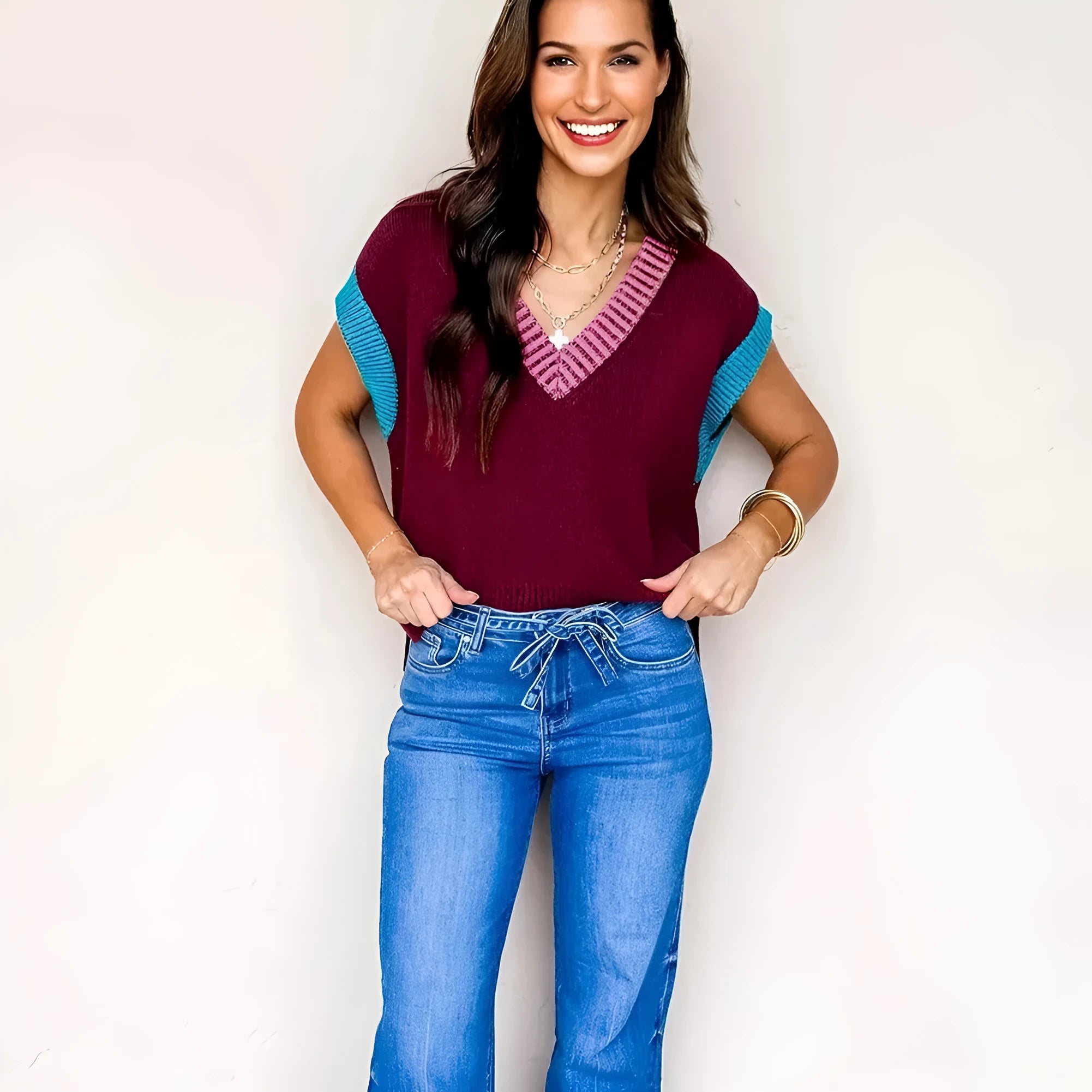 Burgundy loose V-neck short sleeve sweater with contrast trim detail on the neckline and cuffed sleeves.