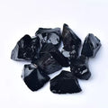 Natural black obsidian rough gravel stones in a pile, size 2-3cm each