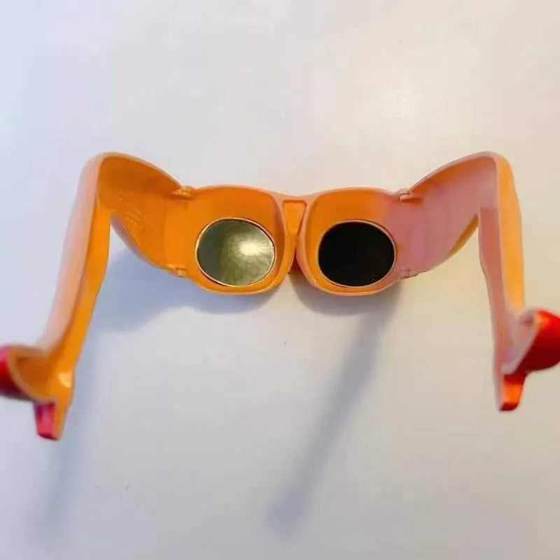 Orange plastic novelty sunglasses with leg and hip design on frame