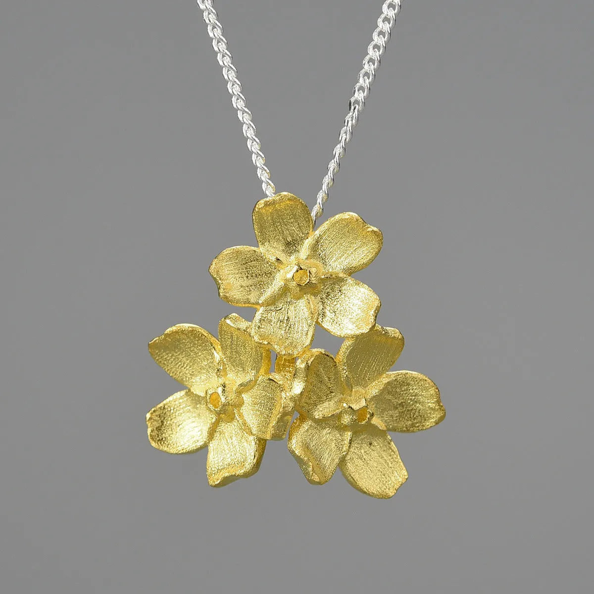 Myosotis Sylvatica sterling silver flower pendant with electroplated finish and hand-designed botanical details