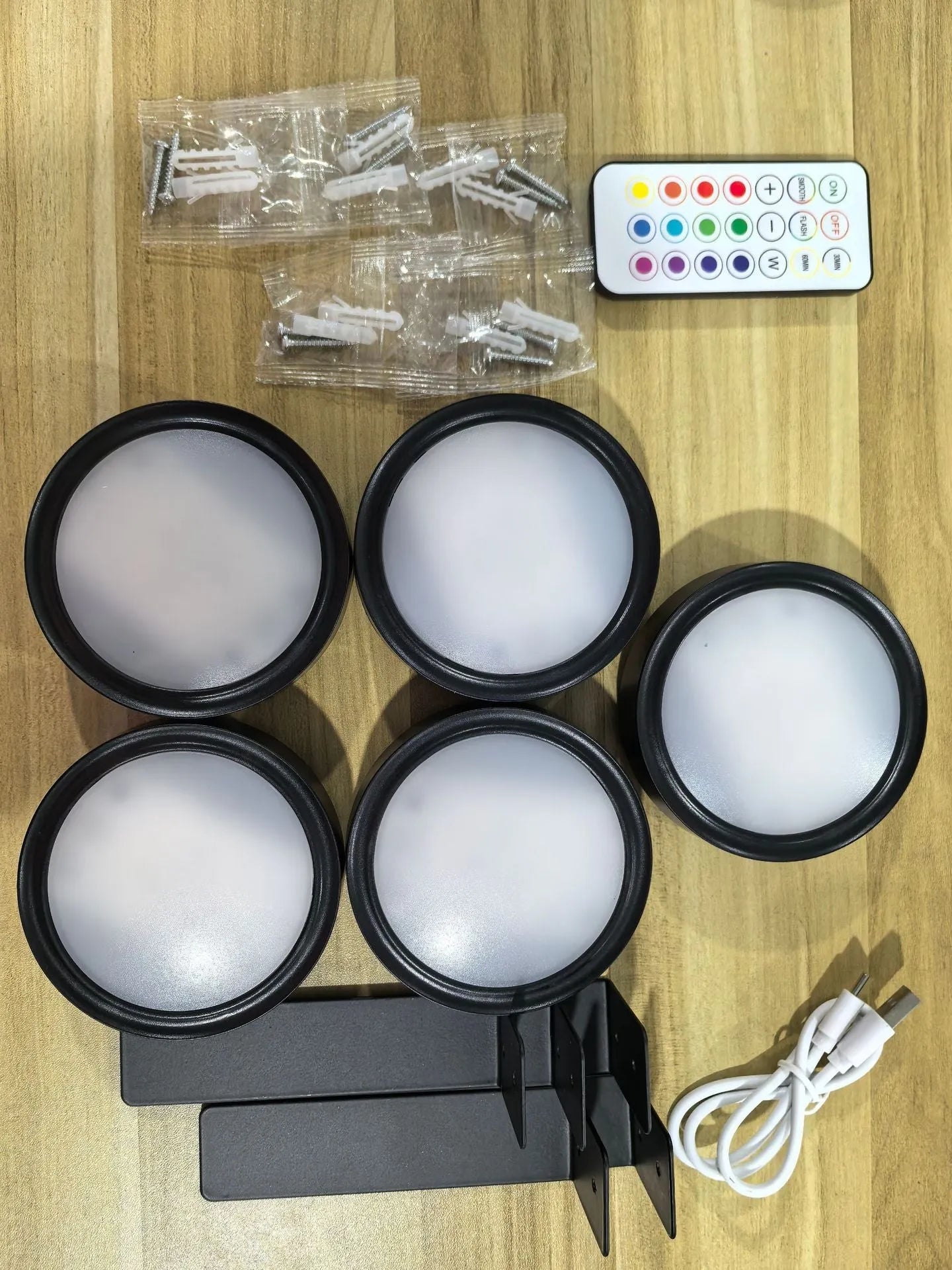 Wireless LED painting lamp with a magnetic mounting belt and remote control in black finish.
