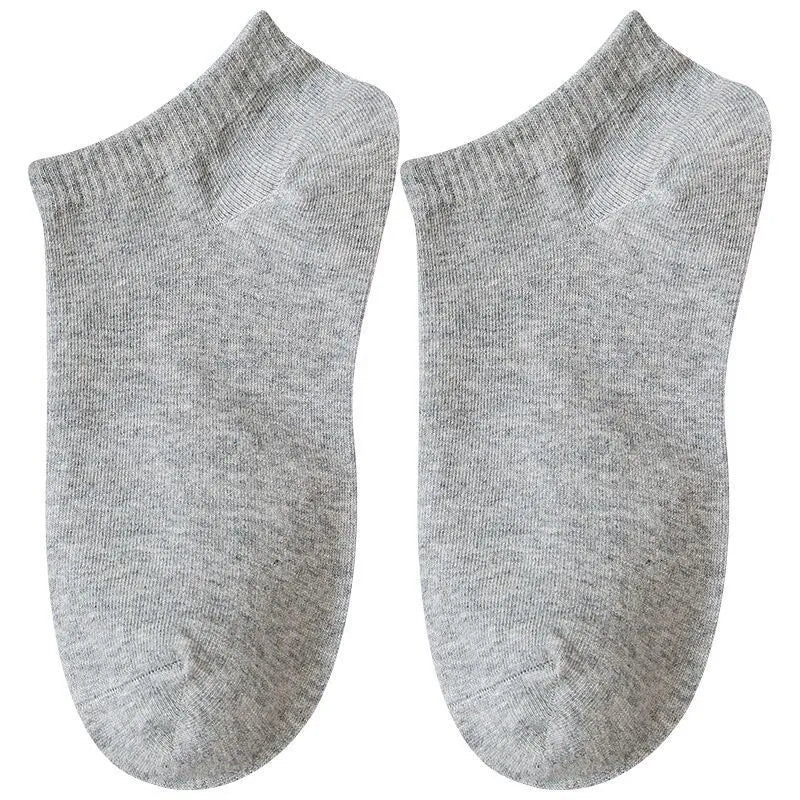 Solid colour men's low cut socks in black, grey, and white with seamless toe construction and blended fabric for breathability.