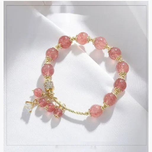 Women's pink crystal bracelet with heart-shaped design and pearl accents in strawberry quartz colour
